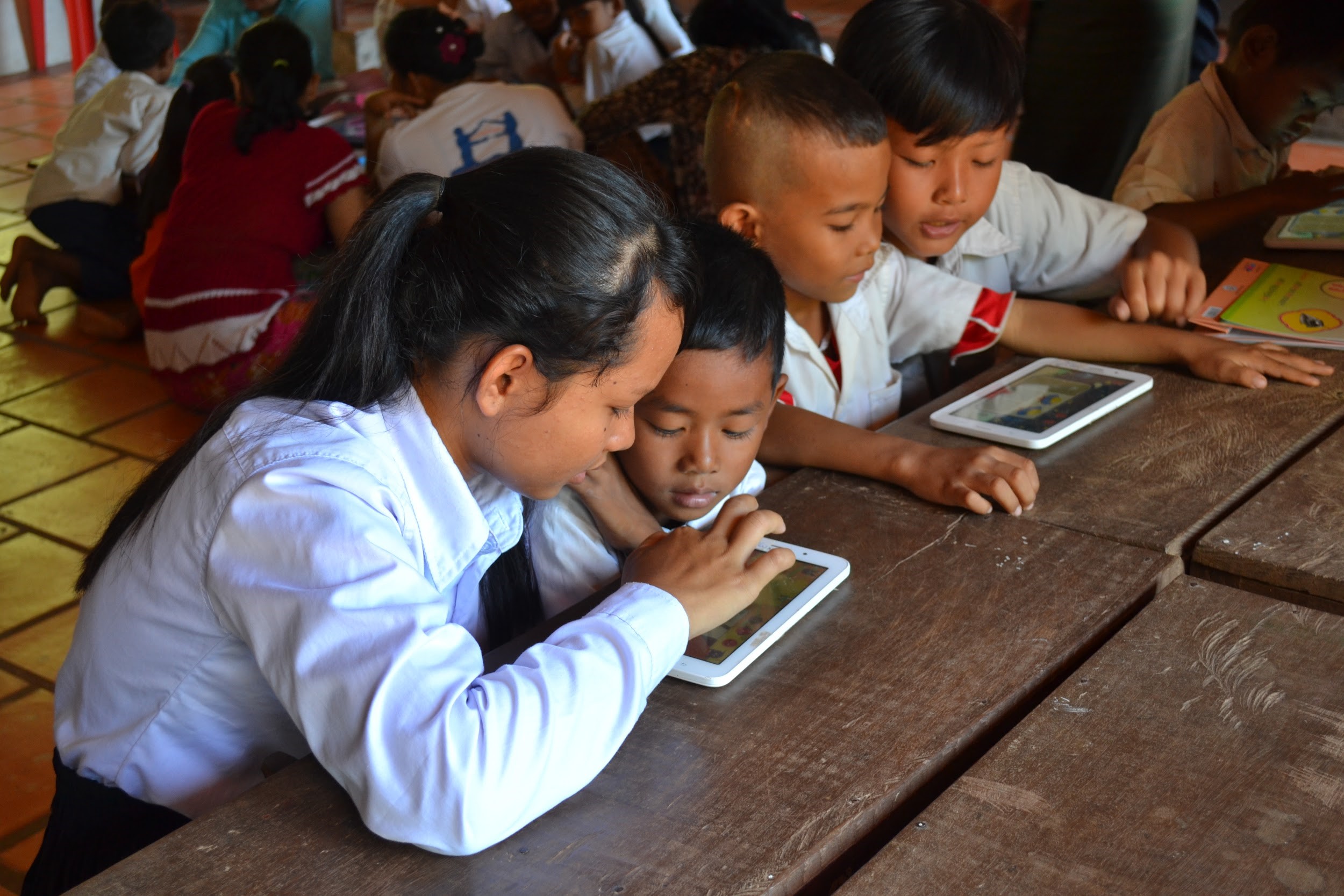 School children playing mobile app game together