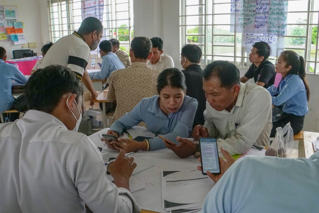 Teachers using technology during training. Cambodia.
